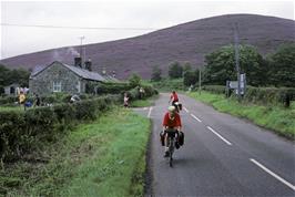 Taking the plunge: turning off the B-road near Hepple for the one-way trip to Alwinton and the track. Blue heather hill beyond