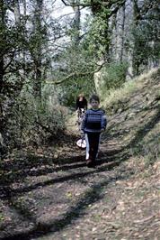 Paul leads the way along the woodland path