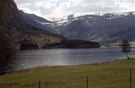 First view of the enormous Jølstravatnet lake from near Skei.  Not far over the distant mountain is the Jostedalsbreen glacier, Fjaerland and Balestrand [New scan, August 2019]