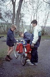 David Platt helps Matthew and Thomas Crabtree load their bikes outside Llandeusant YH [Remastered scan, June 2019]