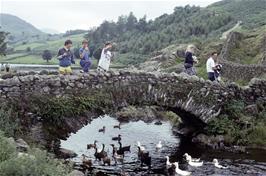 Neil, Rufus & Arthur on the bridge at Watendlath. The track we descended is beyond on the right [Remastered scan, June 2019]