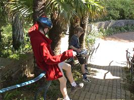 Will and Louis slide down the handrail at the entrance to Salcombe Youth Hostel after our tour of Overbecks National Trust