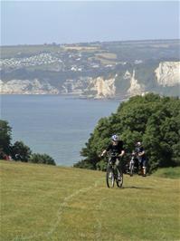 Ashley and Joe climb the steep coast path at Haven Ball, Seaton