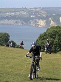 Ashley and Joe climb the steep coast path at Haven Ball, Seaton