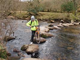 Peter Heathman carefully crosses the stepping stones at Dartmeet