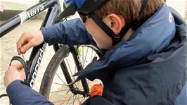 Joe has to put his new bottle cage on for a second time outside Tintagel Youth Hostel, after first putting it on the wrong way around