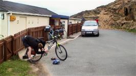Joe oils his chain outside Perranporth Youth Hostel