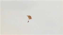 A paraglider descends to Perranprth Airport, as seen from the Coast Path