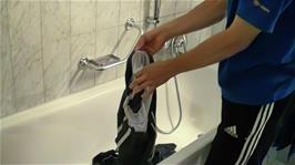 Tao washes his laundry in the bathroom of the Gyrenbad Guest House