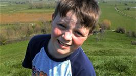Ash introduces himself on camera after rolling all the way down the slope at Burrow Mump