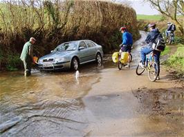 No, he hasn't got stuck in the flood - he's washing his car!