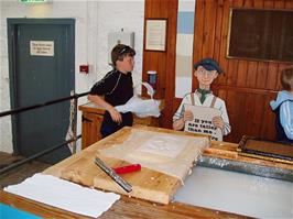 Ash hands over to Alex to make the second piece of paper - new photo for 2025
