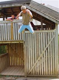 Jordan performs a death-defying leap off Broadhempston Play Park's fort
