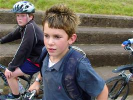 Ash and Reuben by the River Exe as the Millfield School cyclists ride past
