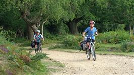 John and George approach Cater's Cottage on the old railway path from Brockenhurst, 11.3 miles into the ride
