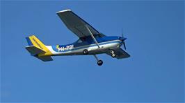 A privately-owned Cessna 172M Skyhawk, specially equipped for aerial photography and based in the Netherlands, flies over Whitby West Pier