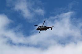 The Coastguard helicopter flies overhead at Torcross