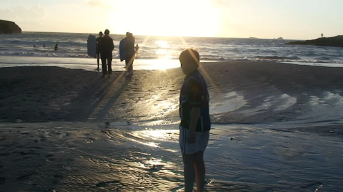 Ash heading out for an evening swim at Treyarnon Bay.