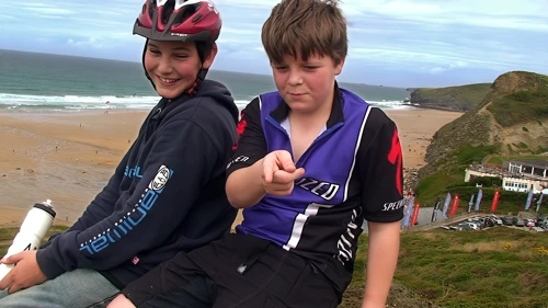 Zac and Ash take a well-earned rest overlooking Watergate Bay, 7.8 miles into the ride